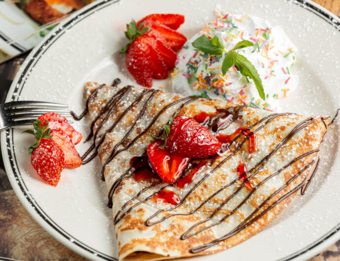 sweet crepe with powder and strawberries
